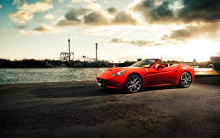 Red sports car road water - the side of a road near a body of water free wallpaper