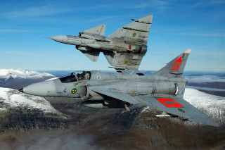 Fighter jet flying mountain range 2 - over a mountain range in the sky free wallpaper